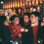 Happy family on Christmas with burning sparklers