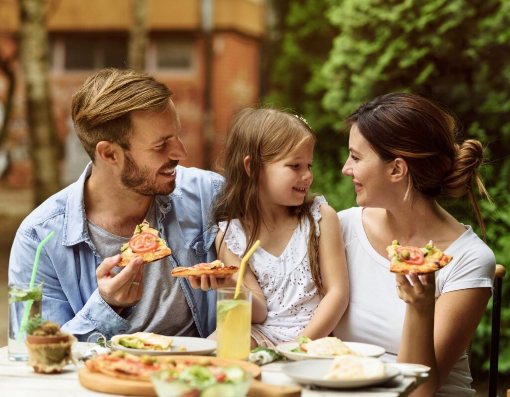 Family enjoying a vegetarian pizza! Check out these Vegetarian Restaurants across Hong Kong!